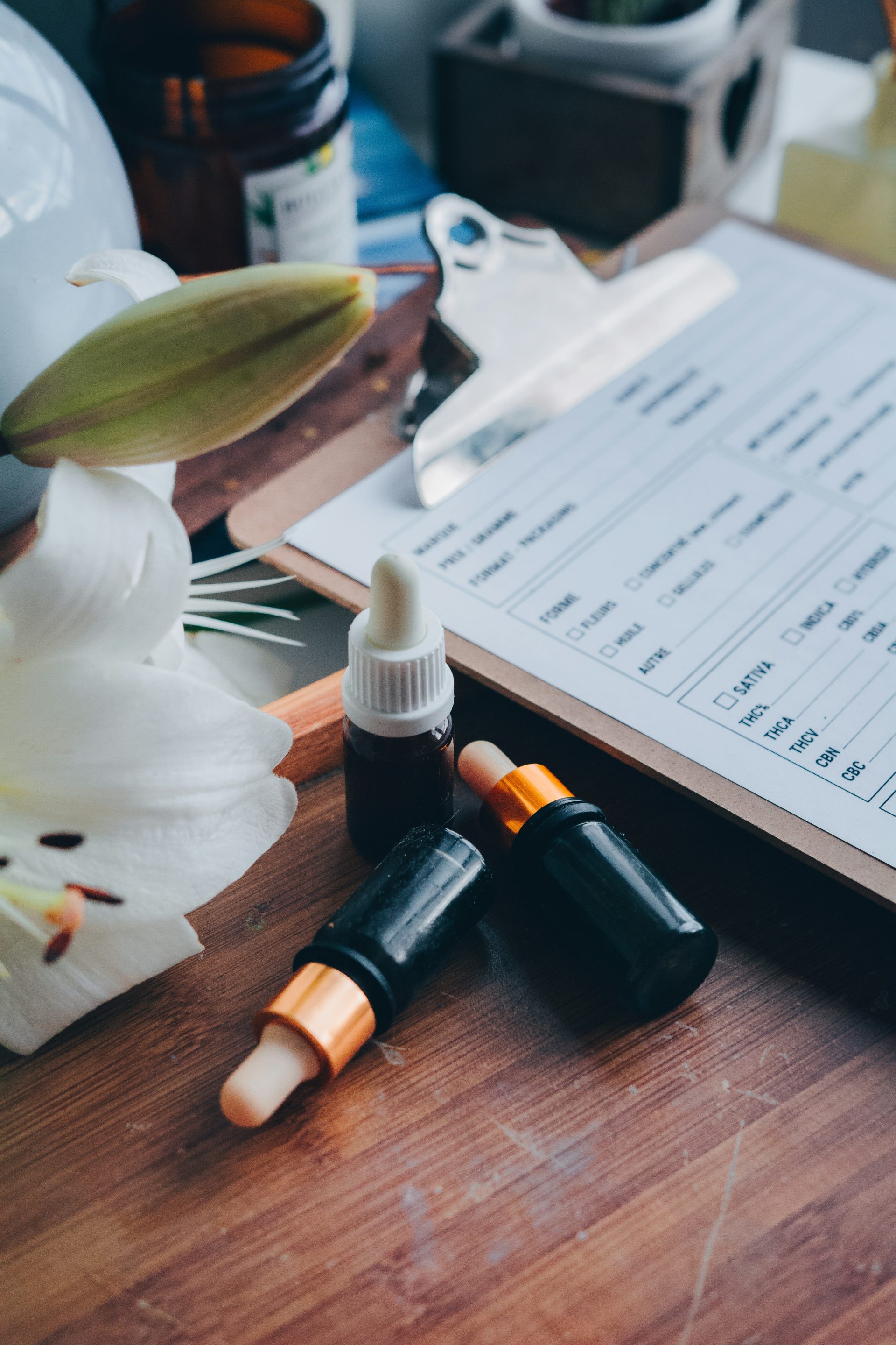 a wooden table topped with three bottles of liquid